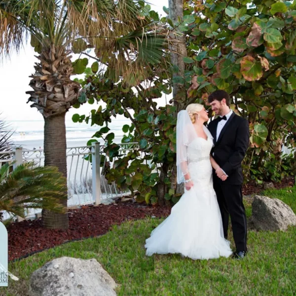 bride and groom standing in the gardens at beautiful oceanfront Plaza Resort & Spa in Daytona Beach Florida