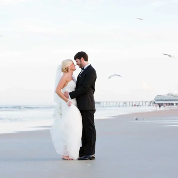bride and groom standing in the sand at beautiful oceanfront Plaza Resort & Spa in Daytona Beach Florida