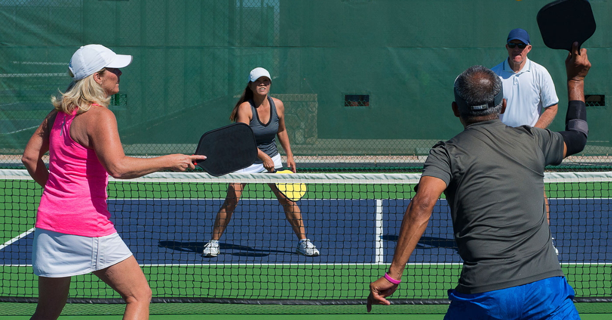 two couples playing tennis