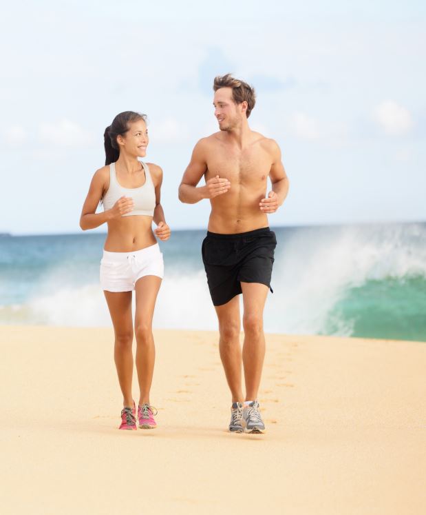 young couple jogging on beach